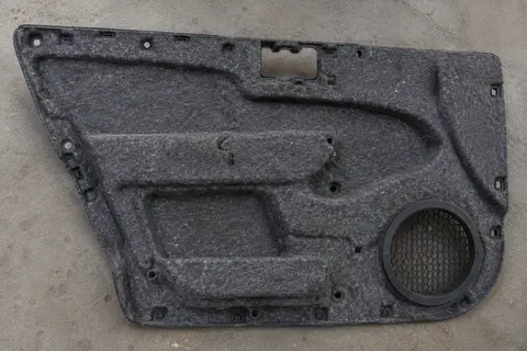 Automotive floor and door panel felt insulation kit installed in a vehicle interior
